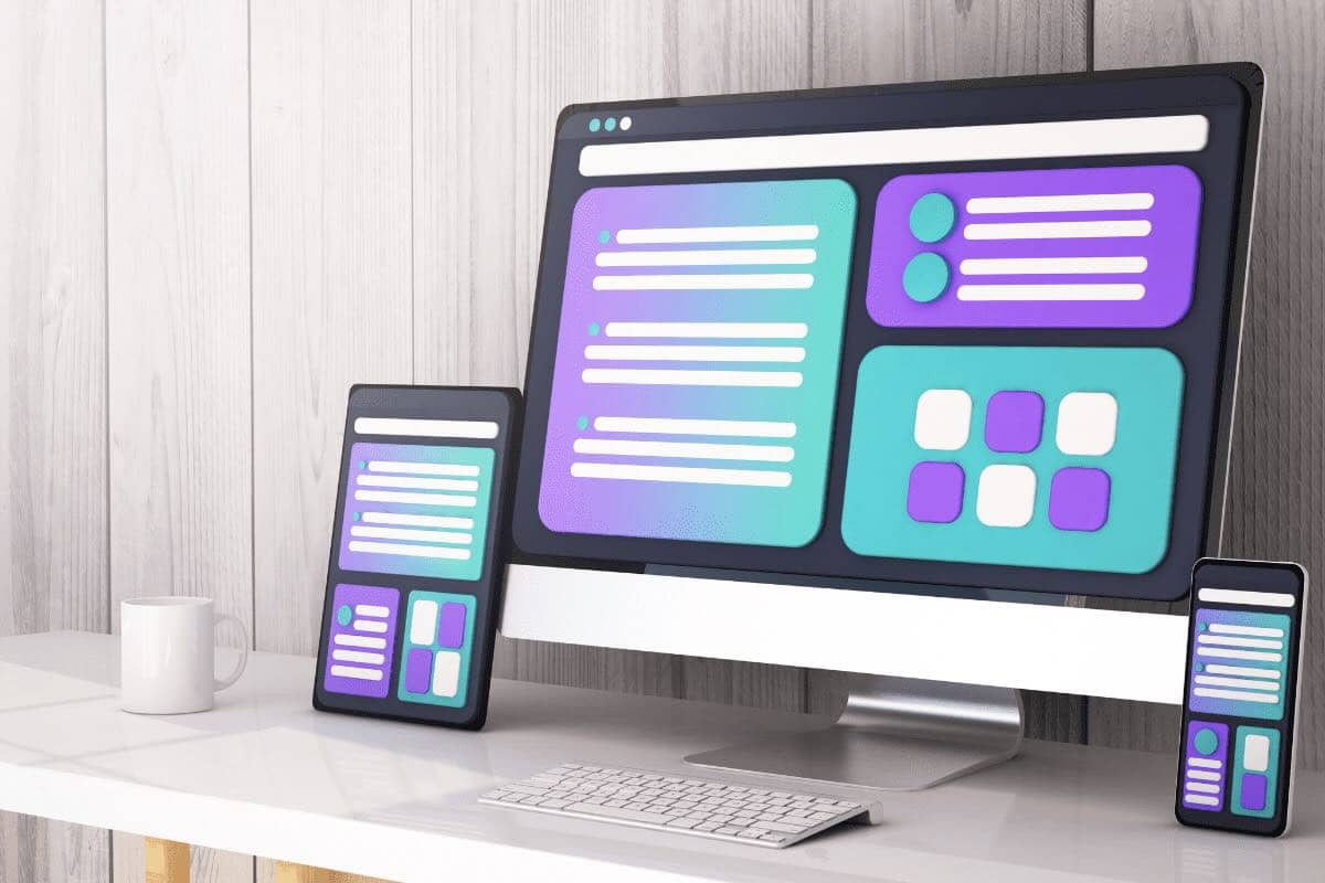 website mockup shown on desktop, tablet and mobile phone on a white desk